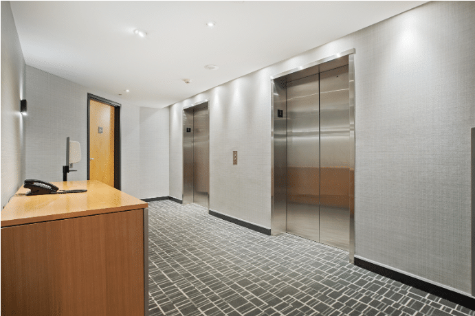 a reception desk ti h two interior lift doors