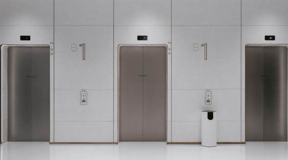 a hallways with three elevator doors
