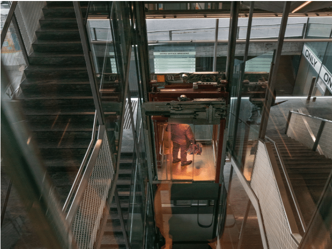 a technician looking at a passenger lift