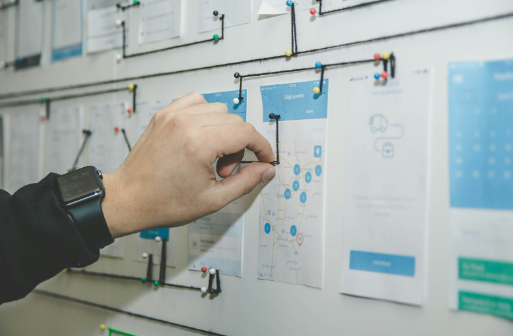 A male hand pinning a map